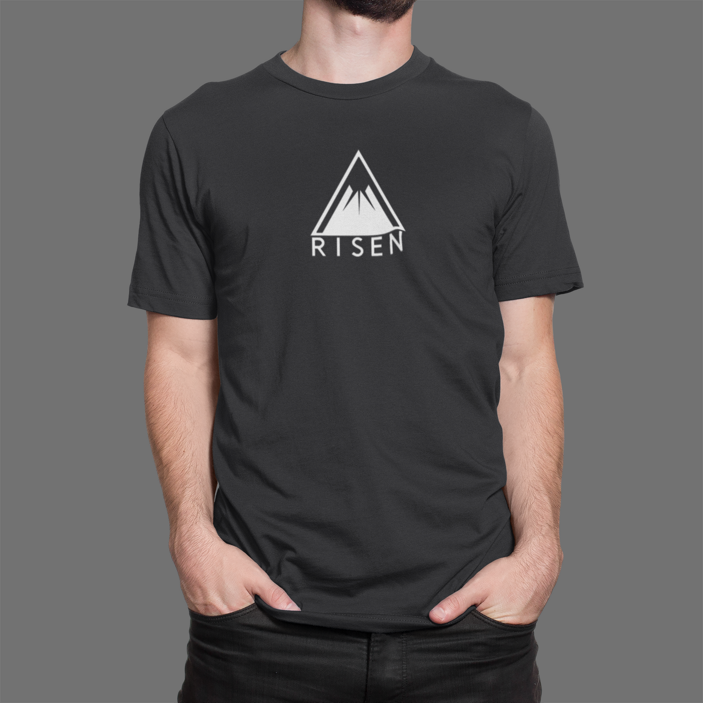The Peak Men’s Christian T-Shirt featuring RISEN mountain graphic design in minimalist style on a dark shirt.
