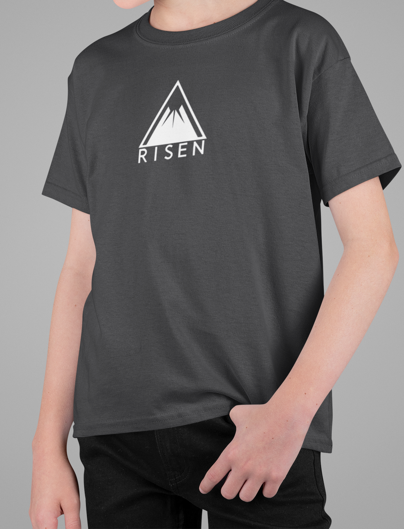 Youth The Peak Christian T-Shirt, RISEN Mountain Graphic Tee worn by a young believer, showcasing a bold mountain design.