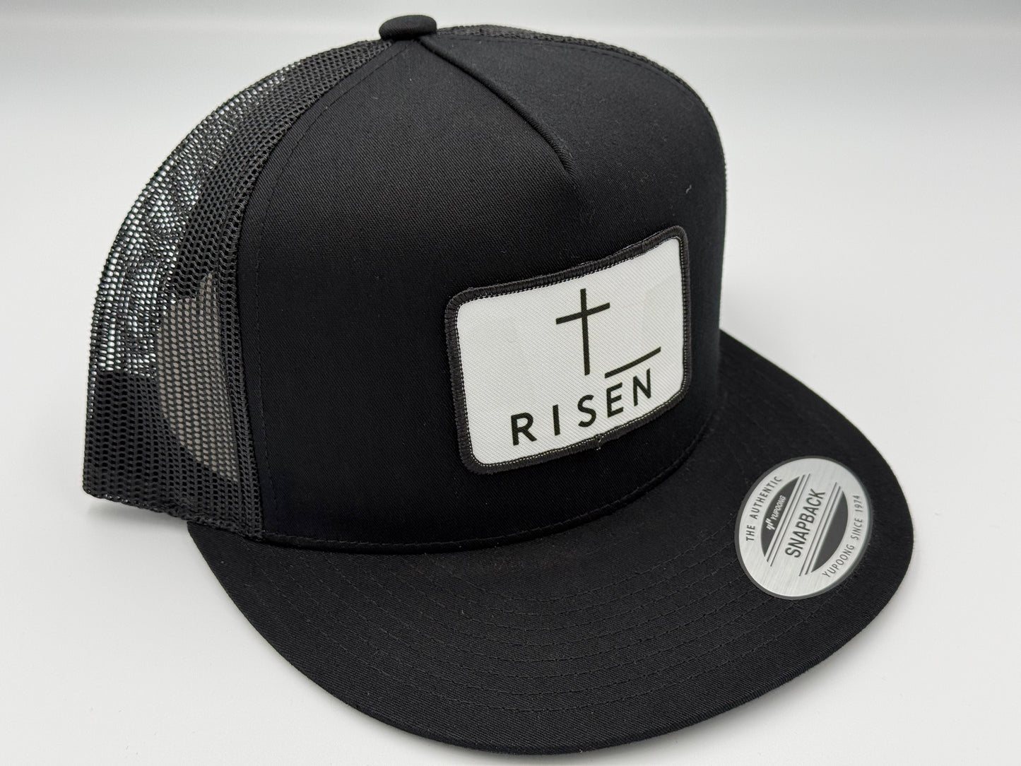 Black Trucker Snapback Hat featuring RISEN canvas patch and structured design for durability and style.