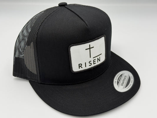 Black Trucker Snapback Hat featuring RISEN canvas patch and structured design for durability and style.