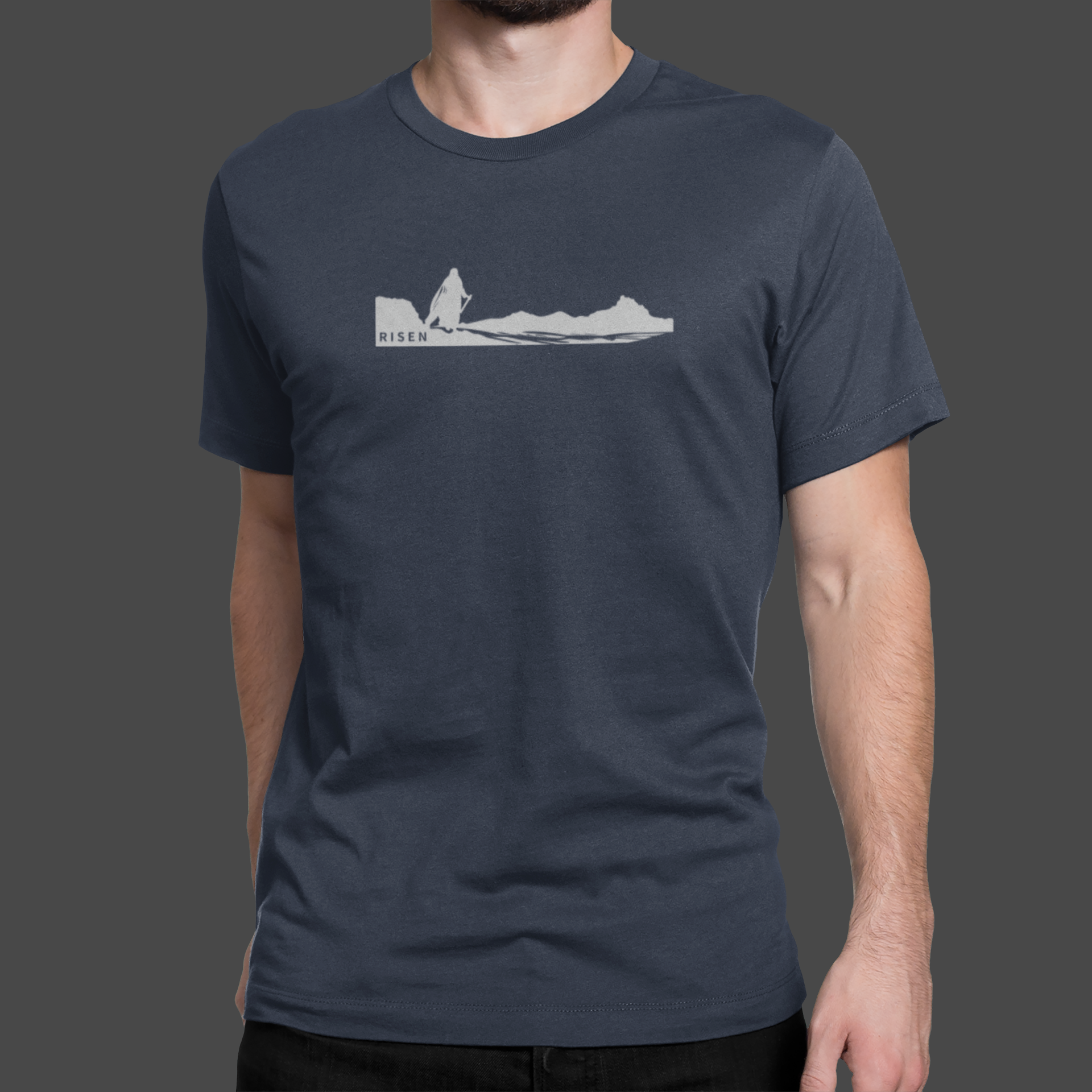 The Way Forward Men’s Christian T-Shirt featuring a RISEN graphic of a figure walking across a desert landscape.