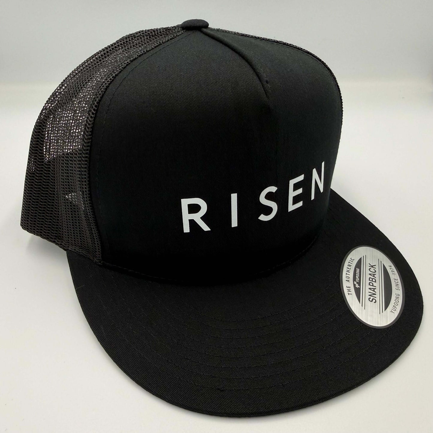 White Risen – Black Trucker Hat