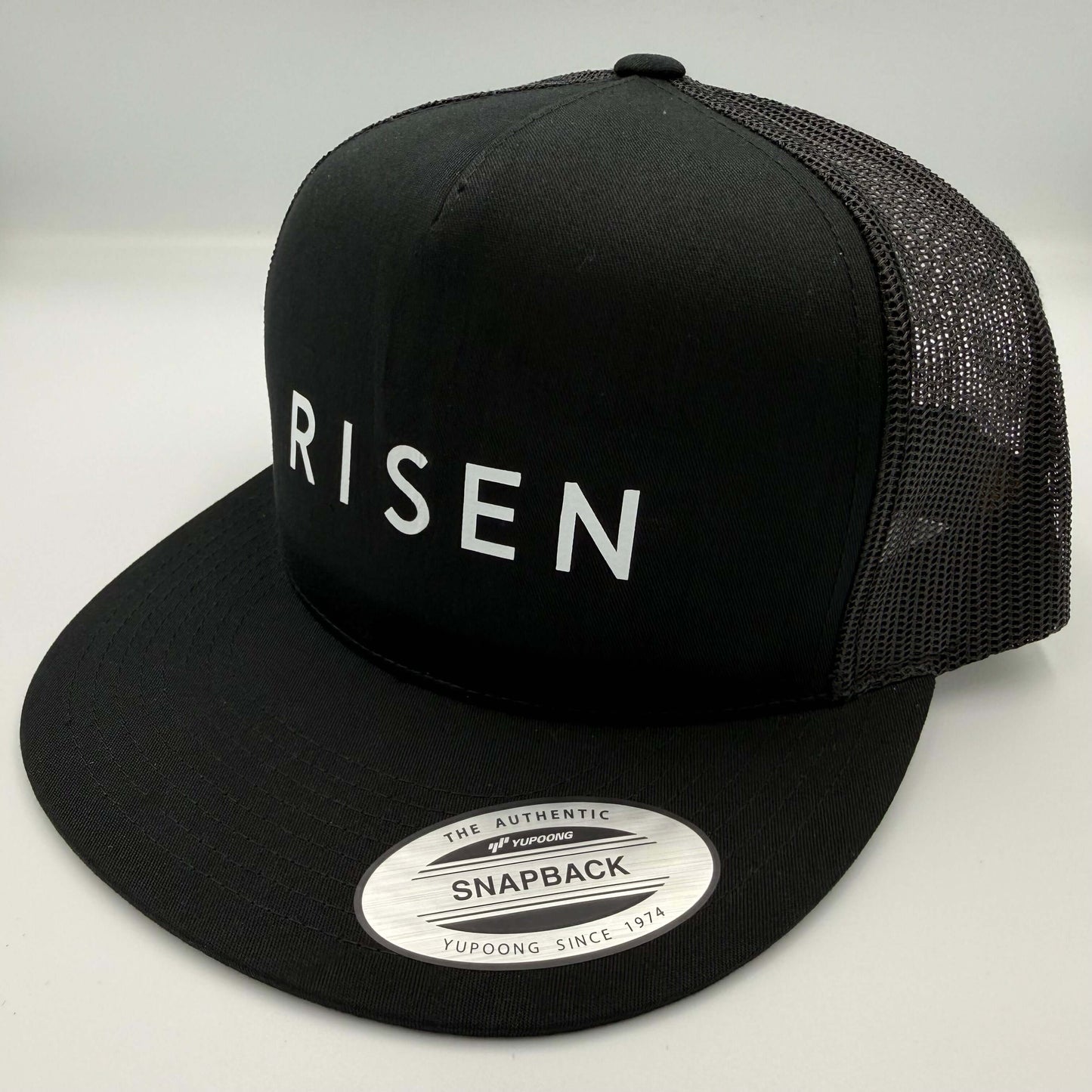 White Risen – Black Trucker Hat