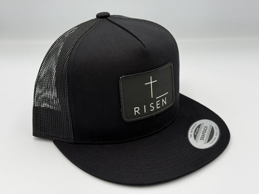 Black Canvas Patch Snapback – RISEN Structured Trucker Hat with a clean design and durable construction.