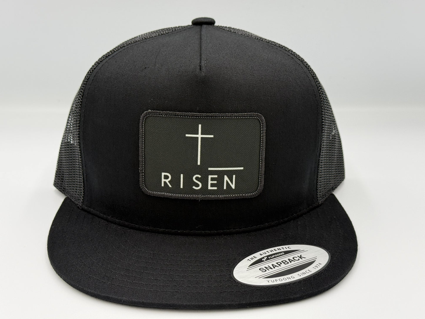 Black Canvas Patch Snapback – RISEN Structured Trucker Hat with a high-profile crown and durable construction.