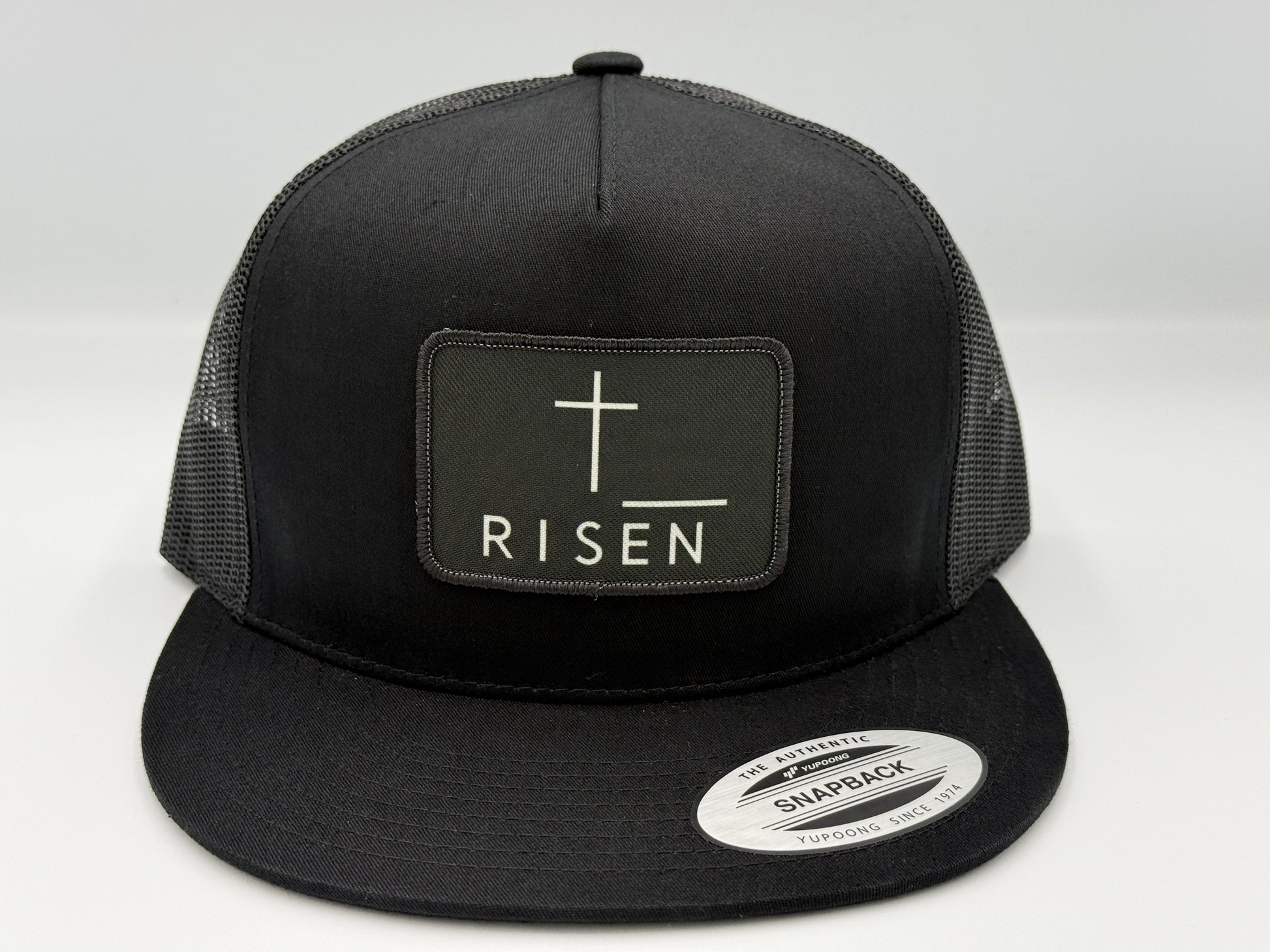 Black Canvas Patch Snapback – RISEN Structured Trucker Hat with a high-profile crown and durable construction.