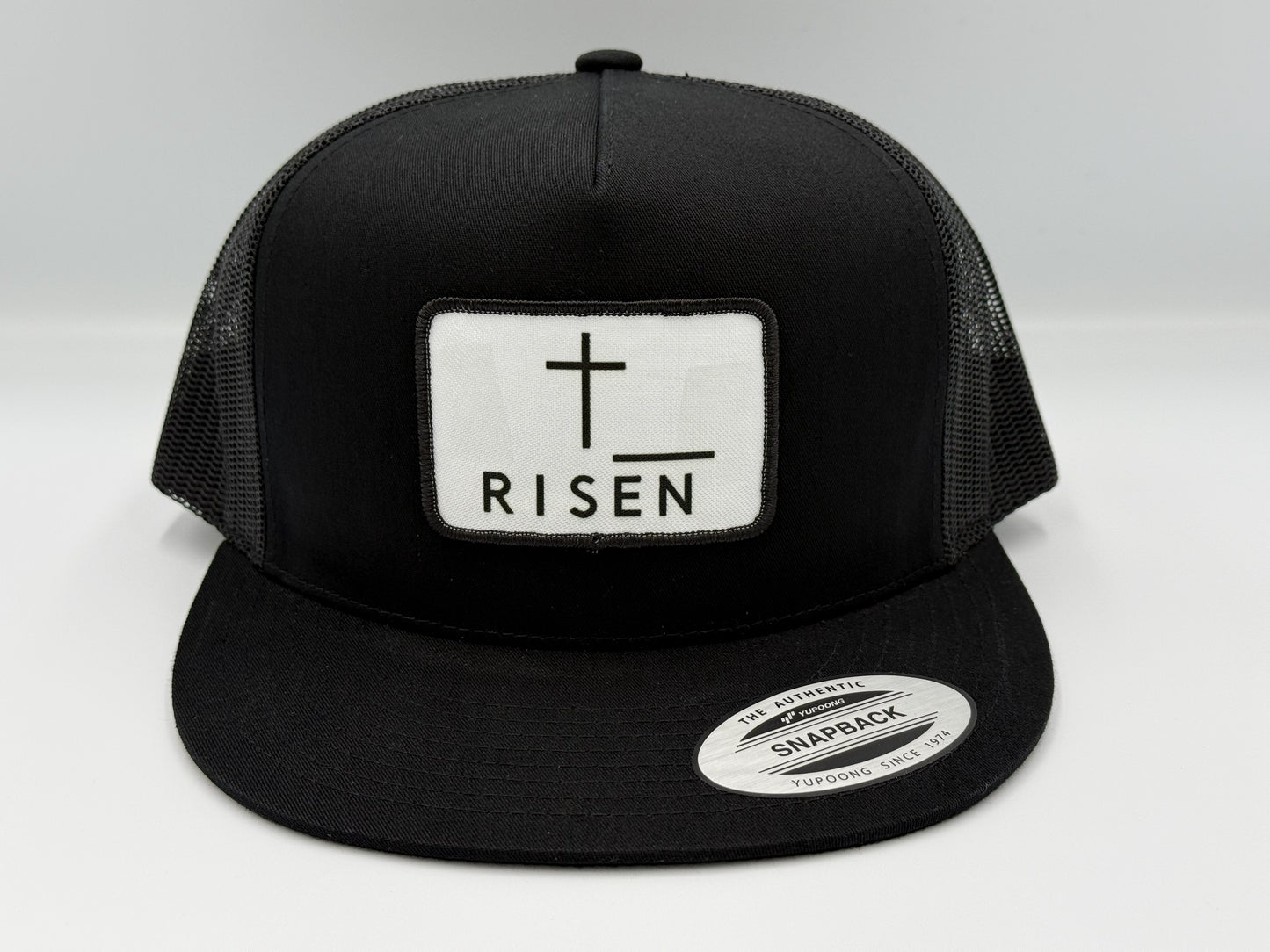 Black Trucker Snapback Hat with RISEN Canvas Patch for style and durability